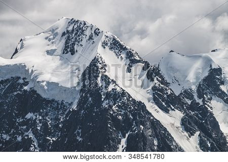 Atmospheric Minimalist Alpine Landscape With Massive Hanging Glacier On Snowy Mountain Peak. Big Bal