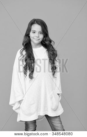 Comfy Style. Kid Wearing Soft Poncho. Wellbeing Concept. Little Girl With Long Hair. Happy Childhood