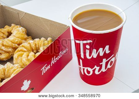 Calgary, Alberta, Canada. Feb 02, 2020. A Box Of Donuts With Honey Cruller Donuts And A Tim Hortons 