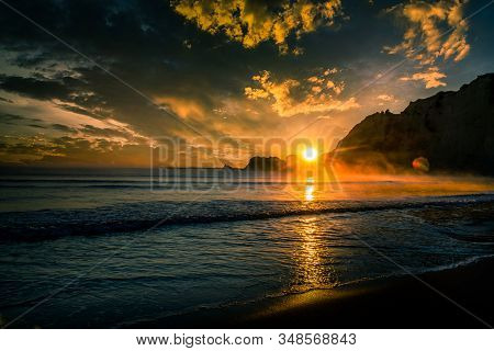 Dramatic Early Morning Sky And Cloudscape And A Stunning Sun Flare And Bokeh At Sunrise Over The His