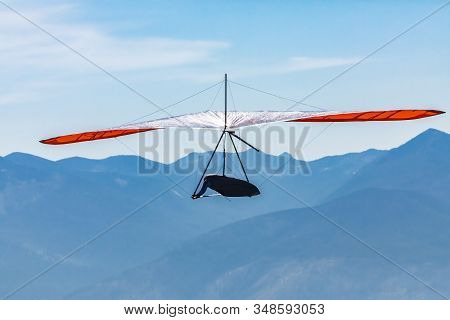 Hang Gliding Against The Silhouette Of Great Mountains In Creston, British Columbia, Canada. Soaring