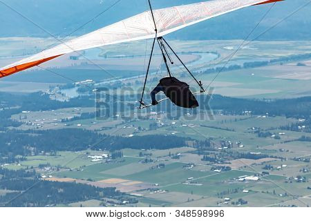 Man With Hang-glider Flying Kootenay Valley Mountains, In Creston, British Columbia, Canada. Recreat