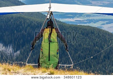 Hang-glider At The Top Of The Hill About To Launch. Paraglider Pilot Taking Off From The Hill At Koo