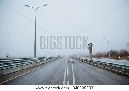 The Dividing Line On The Road Is White The View From Below On The Road Paved Going. Road Markings On