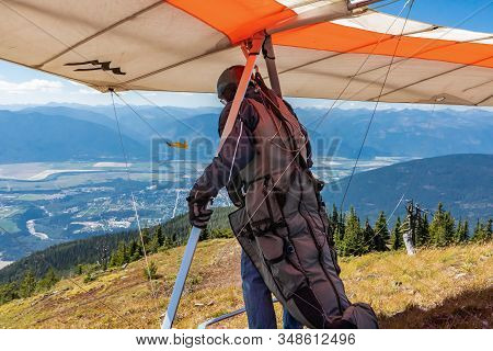 Hang Gliding Para-sailor Preparing To Take Off Above The Hills Of Kootenay Valley Mountains, Creston