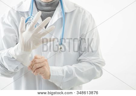 Close-up  Doctor Wearing Gloves Isolated On White Background. Promoting People Use Face Mask To Prot