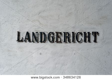 Old Lettering Landgericht In Front Of A White Textured Wall
