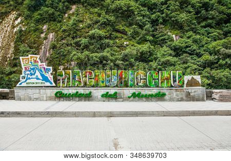 Machu Picchu Pueblo, Peru - Jan 8, 2019: Sign of Town Name at the Roadside of Machupicchu Pueblo or Aguas Calientes with Urubamba river in back,  Peru,