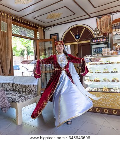 Bakhchisaray, Crimea - Jul. 2. 2019. A Woman In A National Tatar Costume Is Dancing. Degirmen - Nati