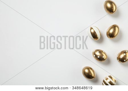 Egg Hunt Is Coming. Easter Traditions, Golden Colored Eggs On White Background, Top View, Copyspace 
