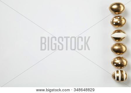 Egg Hunt Is Coming. Easter Traditions, Golden Colored Eggs On White Background, Top View, Copyspace 