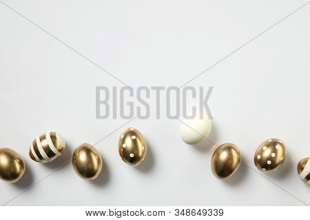 Egg Hunt Is Coming. Easter Traditions, Golden Colored Eggs On White Background, Top View, Copyspace 