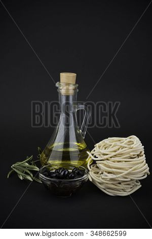Different Spaghetti And Olive Oil On Black Background. Pasta.