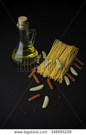 Different Spaghetti With Olive Oil On Black Background. Pasta.