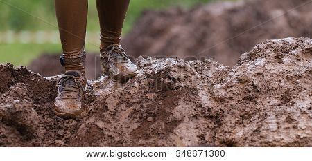 Mud Race Runners Detail Of The Legs, Muddy Running Shoes A Run In The Mud