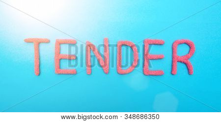 The Word Tender In Red Letters On A Blue Background. The Concept Of Competitive Procurement From A G