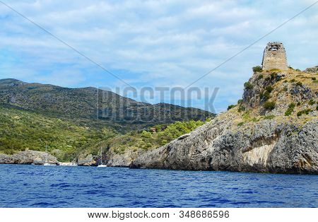 Cala Bianca Beach And The Saracen Tower Near Camerota From The Sea, Campania, Italy