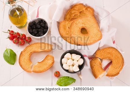 Friselle With Tomatoes And Mozzarella Cheese On Wooden Table.