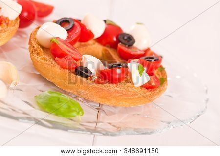 Friselle With Tomatoes And Mozzarella Cheese On Wooden Table.