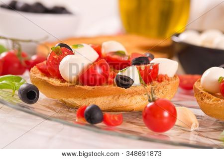 Friselle With Tomatoes And Mozzarella Cheese On Wooden Table.