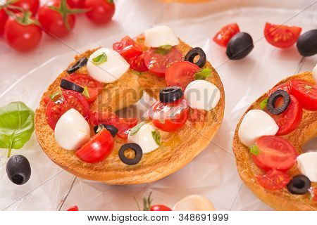 Friselle With Tomatoes And Mozzarella Cheese On Wooden Table.