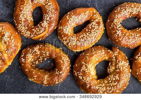 Bagel Sesame Golden Bake Color, Soft Inside, Crispy Outside. Top View Bagel. Heap Of Fresh Baked Bag