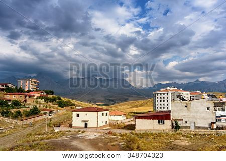 Mountain Houses With Clouds On The Sky, Turkey