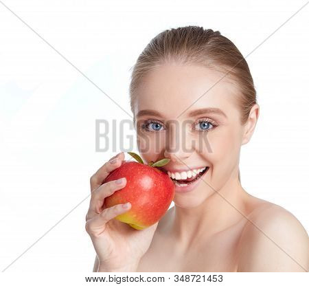 Portrait Of Happy Smiling Young Beautiful Woman Eating Red Apple, Over White Background