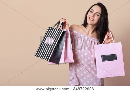 Iage Of Smiling Good Looking Attractive Brunette Looking Directly At Camera, Smiling Sincerely, Hold