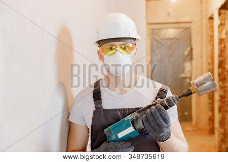 Builder Worker Man Makes Selfie Photo With Safety Glasses And White Helmet With Pneumatic Hammer Dri