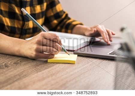 Quick Note. Close Up Hands Of A Businesswoman, Student Or Freelancer In Yellow Shirt Making A Note O