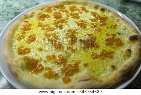 Caviale Pizza With Mozzarella Cheese And Red Salmon Caviar Is On The Cooking Table.