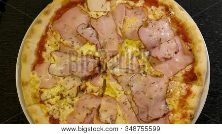 Karnos Pizza With Cheese, Sauce And Ham, Bacon, Smoked Chicken And Egg Is On The Table 1