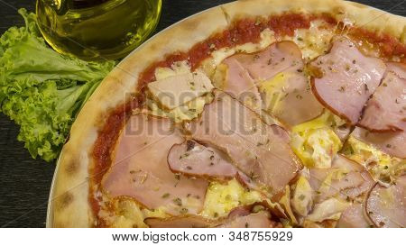 Karnos Pizza With Cheese, Sauce And Ham, Bacon, Smoked Chicken And Egg Is On The Table