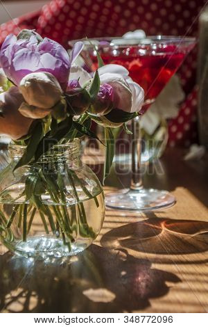 Beautiful Little Bouquet Of Undiscovered White Pink Peonies Against The Background Of A Red Drink In