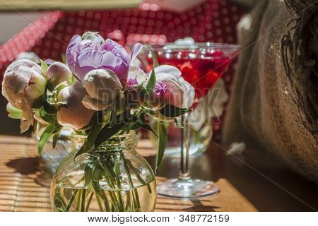 Beautiful Little Bouquet Of Undiscovered White Pink Peonies Against The Background Of A Red Drink In