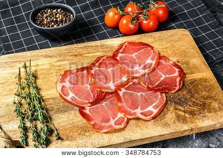 Raw Smoked Meat Jamon Lomo. Black Background. Top View
