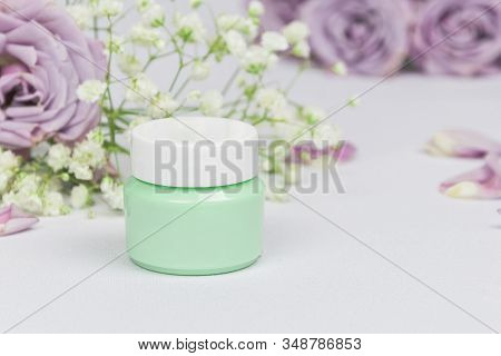 Green Cosmetic Jar With Cleansing Balm (oil) On A White Background With Flowers Roses And Petals, Mo