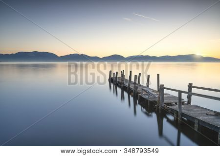 Wooden Pier Or Jetty And Lake At Sunrise. Long Exposure. Torre Del Lago Puccini, Versilia, Massaciuc