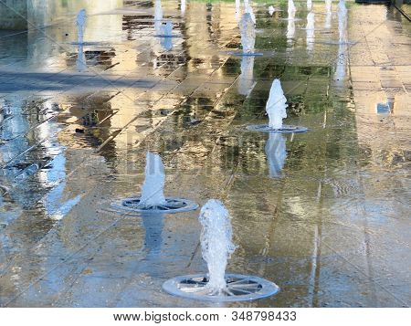 Fountain In City Park, Many Jets Of Water Shooting Up At Different Heights And Intervals Like A Geys