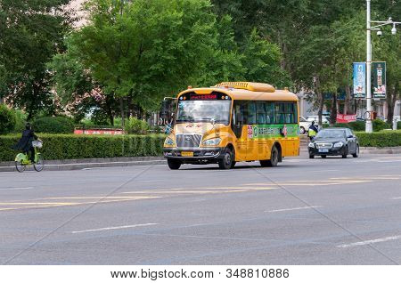 China, Heihe, July 2019: Yellow School Bus On Heihe City Road In Summer