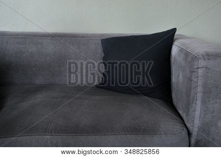 Relaxing Seat In The Corner Of The Room. Seat Tone Gray Color In Room With Pillow Black.