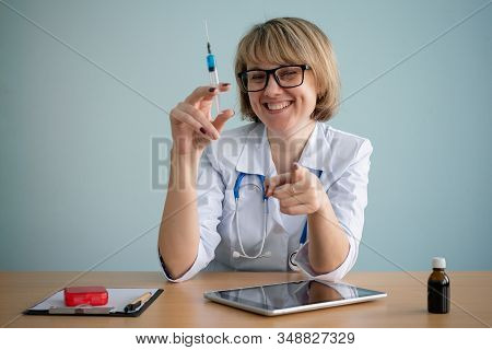 Doctor With Syringe In Hands Close Up.