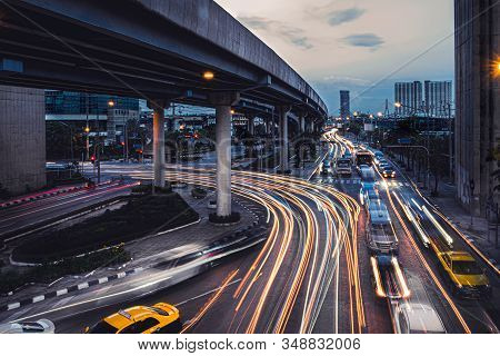 Car Lights At Evening On The Road Going To The City. Aerial View Of The Speed Traffic Trails On Moto