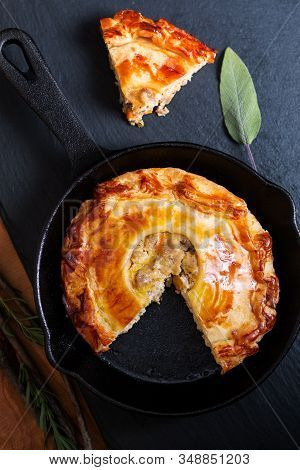 Food Concept Homemade Golden Meat Puff Pastry Pie In Skillet Iron Cast On Black Slate Board With Cop