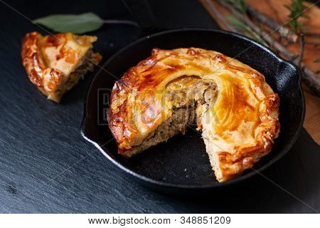 Food Concept Homemade Golden Meat Puff Pastry Pie In Skillet Iron Cast On Black Slate Board With Cop