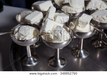 White Ice Cream In Metal Ware In The Tray. Selective Focus. Stainless Ice Cream Cup That Arrange In 