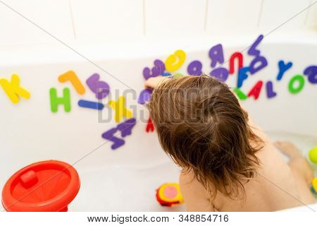 Little Girl Is Playing Foam Lettern In The Bath. Learning Abc With Play. Montessori Activity