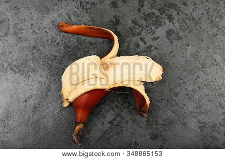 Red Bananas On A Dark Background. Red Bananas Are Shorter, A Kind Of Banana. Brown Banana Variety.
