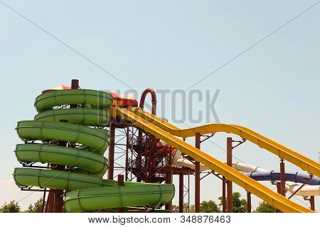 Long Spiral And Straight Water Slides In The Outdoors Seasonal Water Park At Day Time